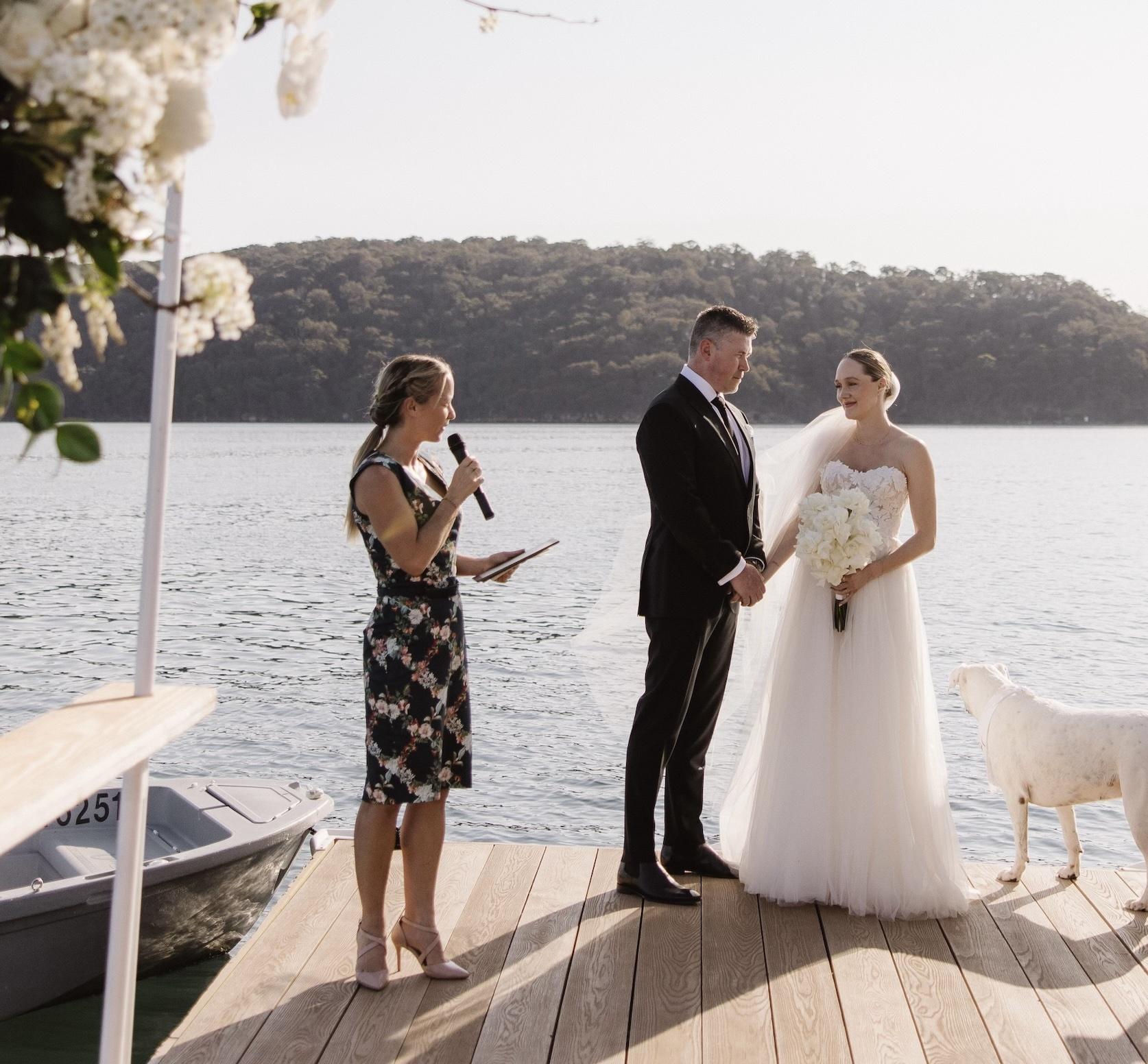 Wedding ceremony at Shelly Beach, guests gathered close.