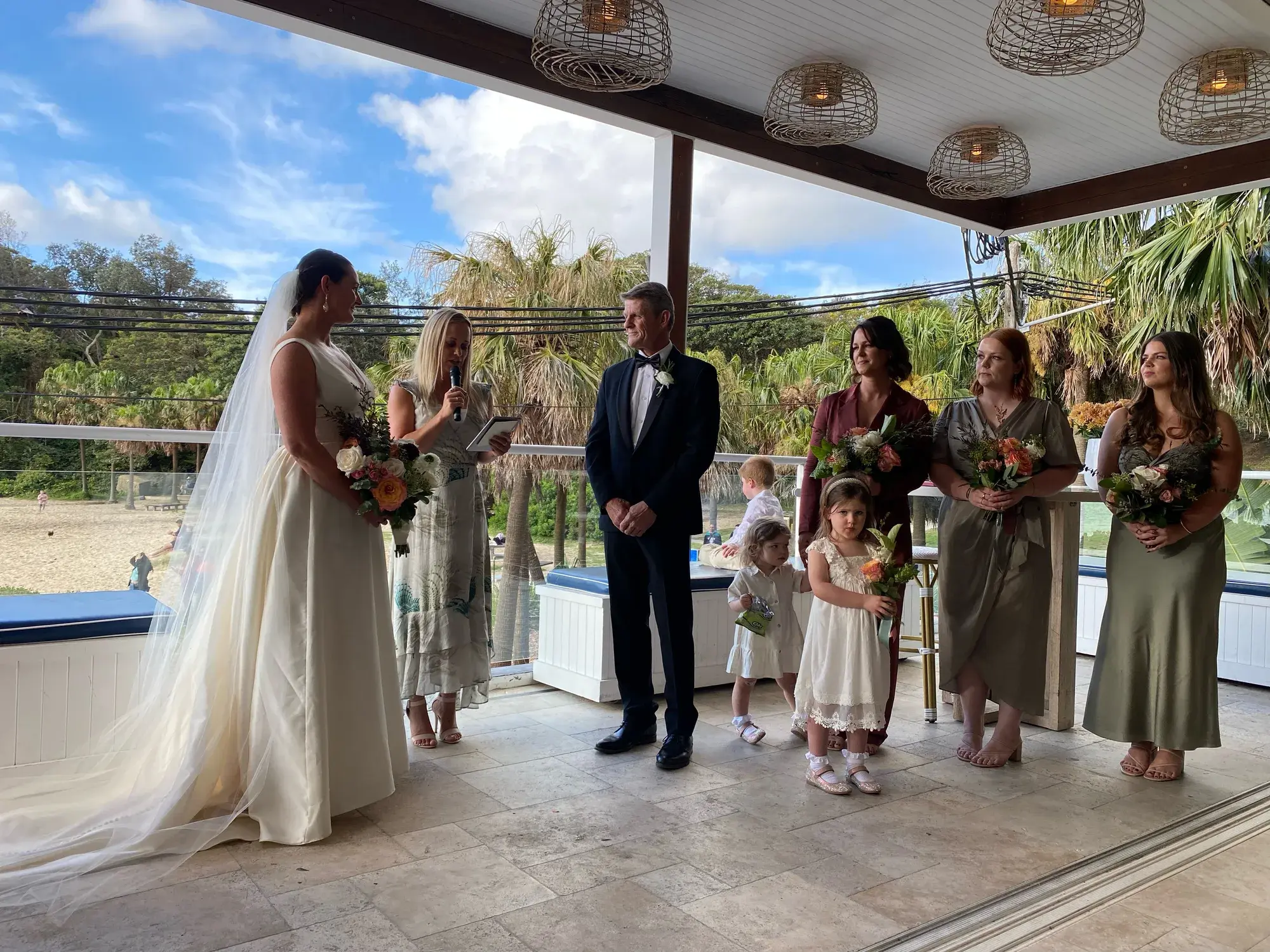 Wedding ceremony on Sydney Harbour, the couple at the water's edge.